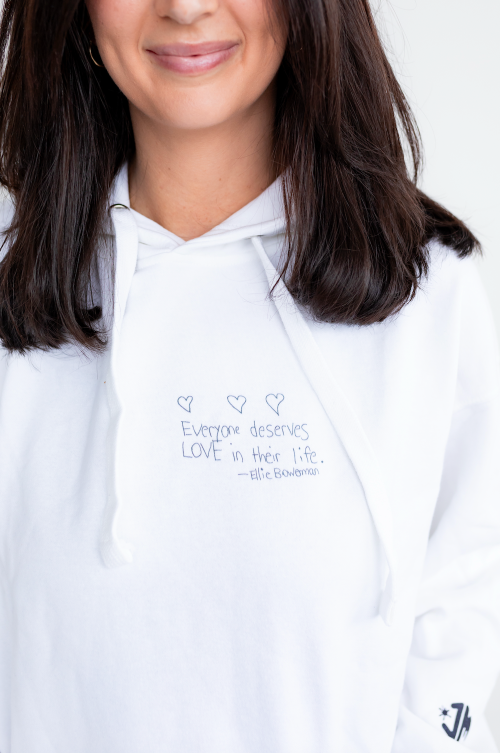 Female model wearing Maximizer Ellie's white "Love" hoodei