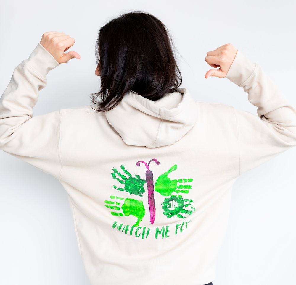 Female model wearing Maximizer Hayden's "Watch Me Fly" white hoodie