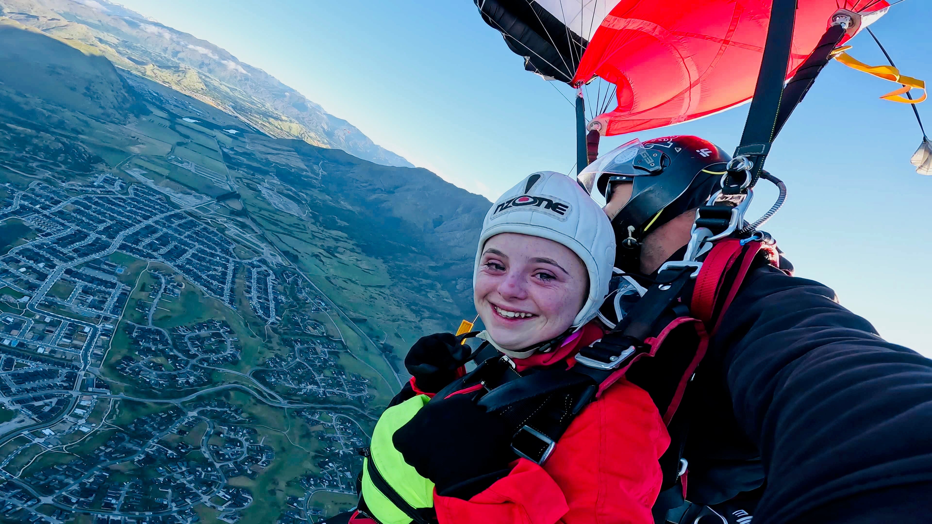 Maximizer Ellie skydiving tandem over mountains